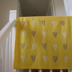 yellow baby blanket with sewn on hearts