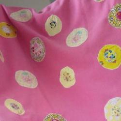 pink baby blanket with yellow and cream circles