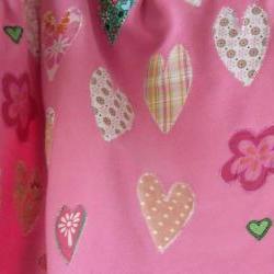 pink baby blanket with hearts and flowers